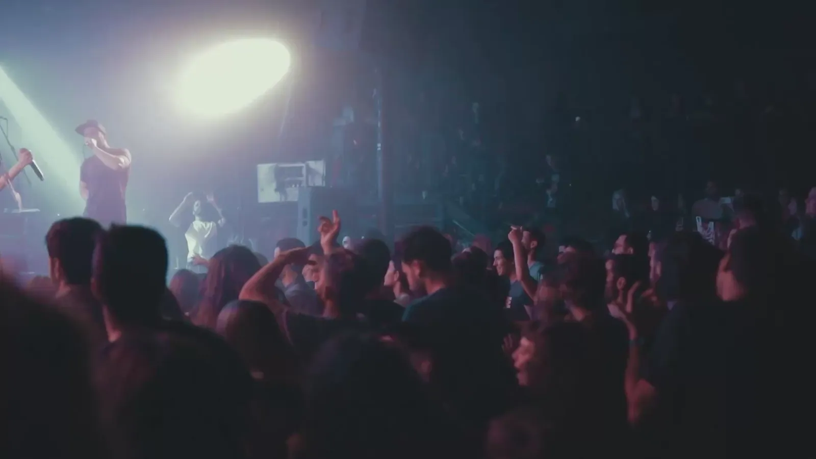 Live concert with performers, stage lights and a crowd